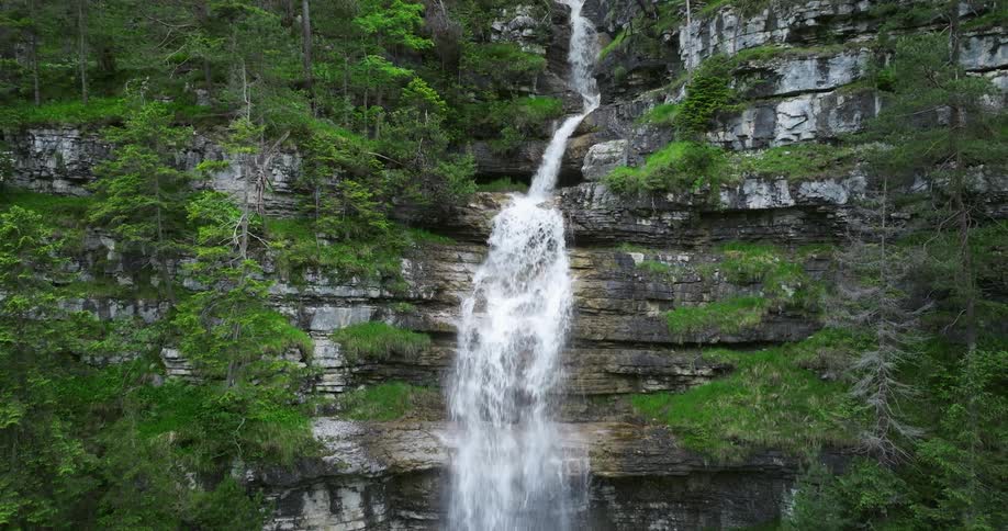 The waterfall is pouring off the mountain