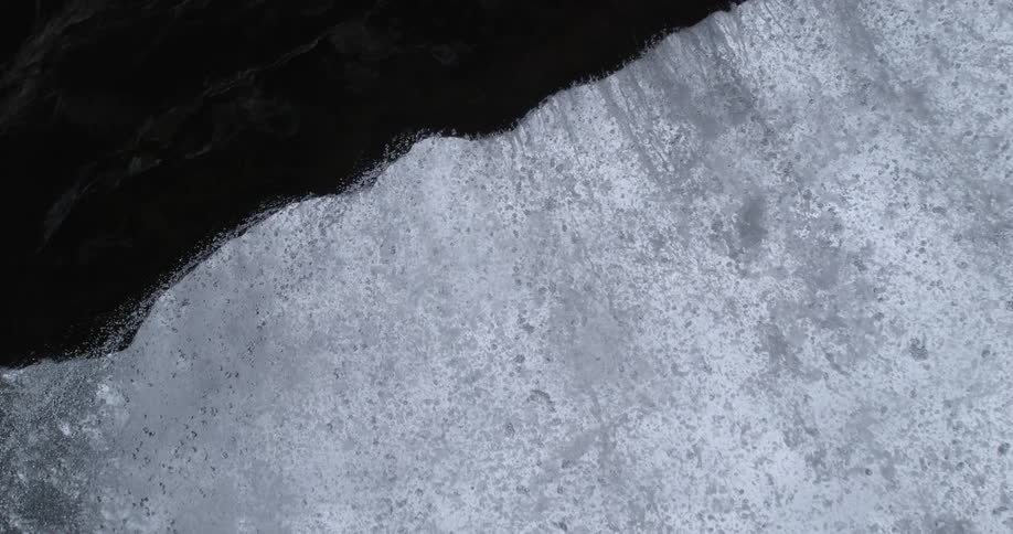 River water flowing over the edge of a rock cliff waterfall