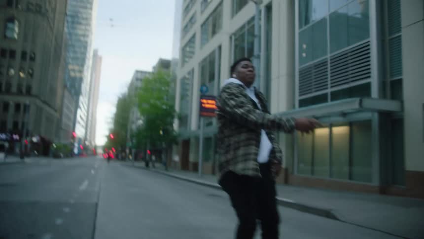 Black man dances on the city street