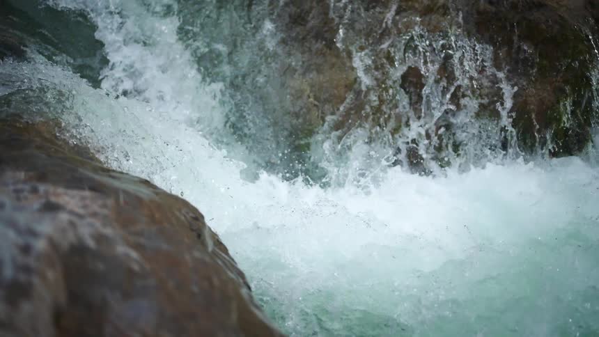 Water sparkles and splashes as it flows over the waterfalls