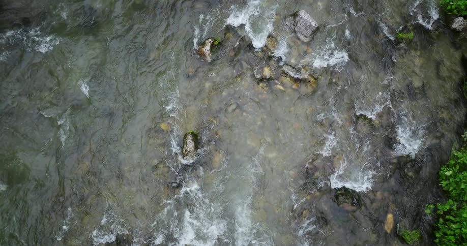 The rapids stream below