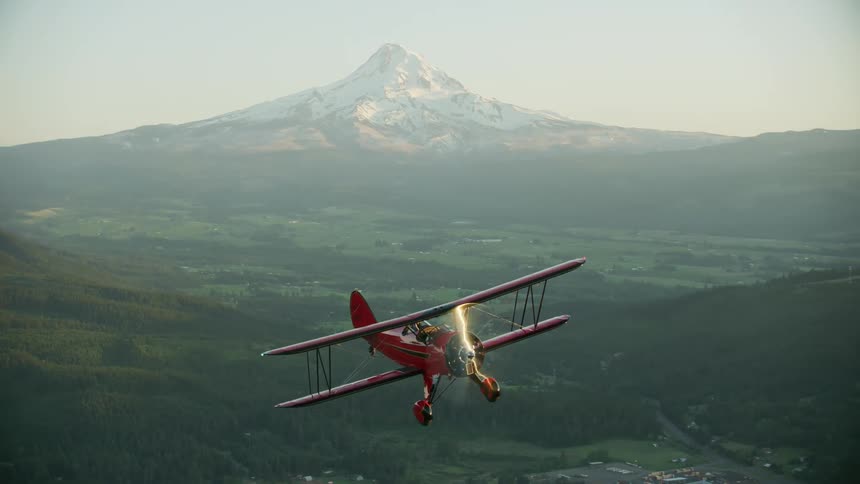 The plane glides above Mount Hood in Oregon on a beautiful summer evening