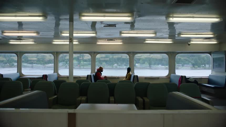 Two people are riding the ferry