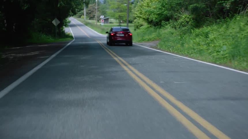 A view of a car driving down a road