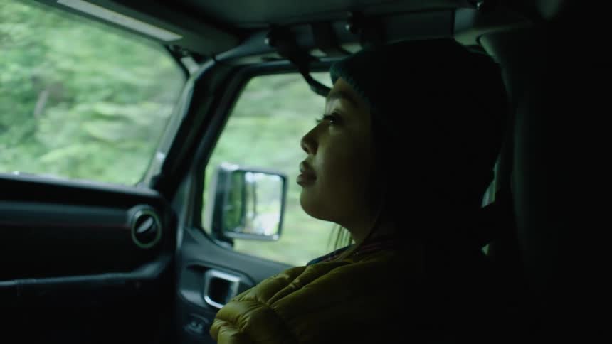A woman is riding in the car
