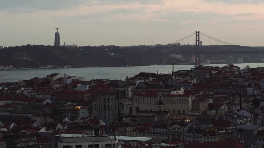 The sun is setting in the horizon of Lisbon