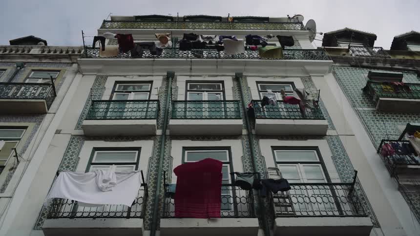 Clothes are hanging on the balcony of a building