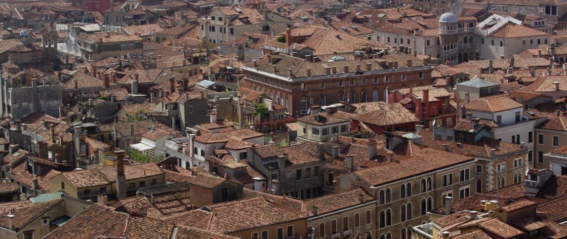 Apartment buildings with terracotta roofs fill a dense neighborhood