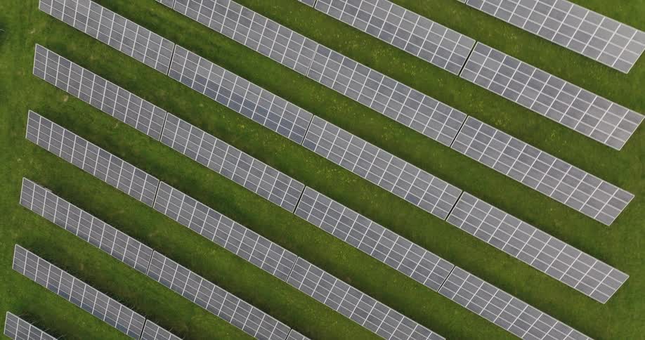 Solar panels at solar farm reflect the light
