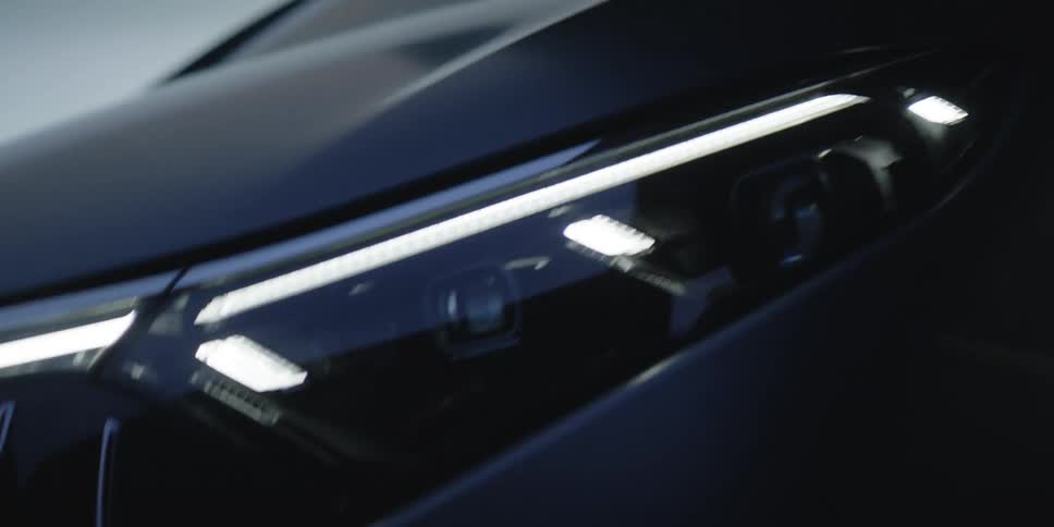 Close up view of a front of a car is displayed outdoors