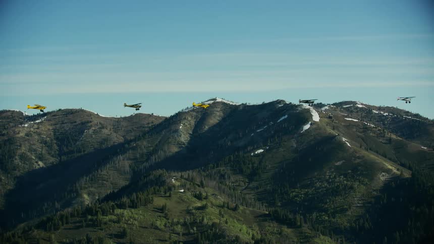 Carbon Cubs in formation fly over a high altitude mountain pass in Idaho