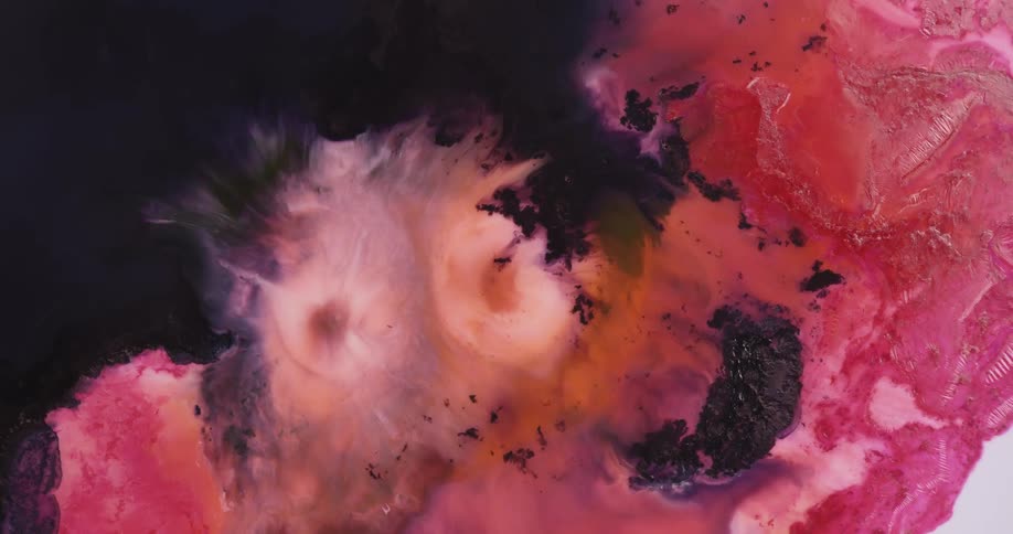Colorful hues of pink blue purple peach and orange hues of paint mix together in a watercolor like effect