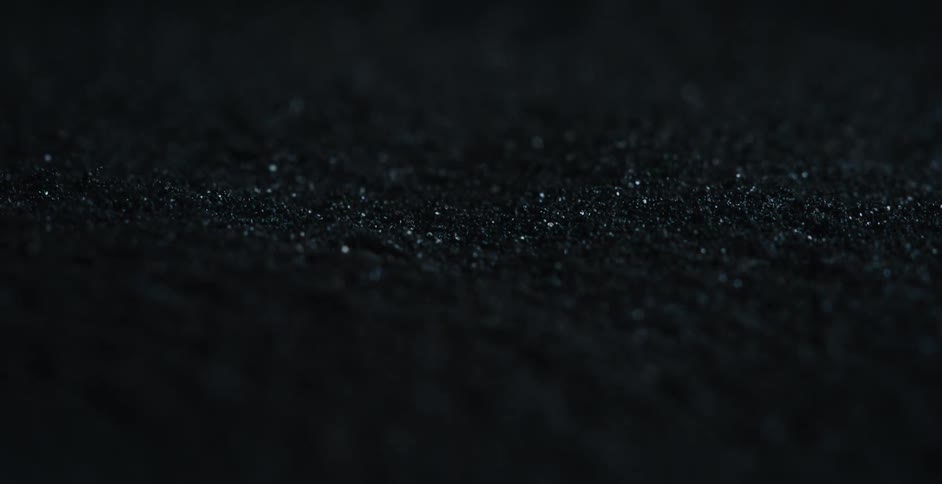 Light shines on iron shavings that are moving under the force of a magnet