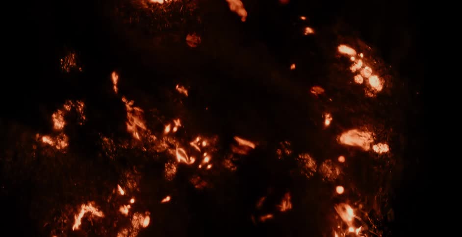 Molten fiery lights explode and move across the darkness