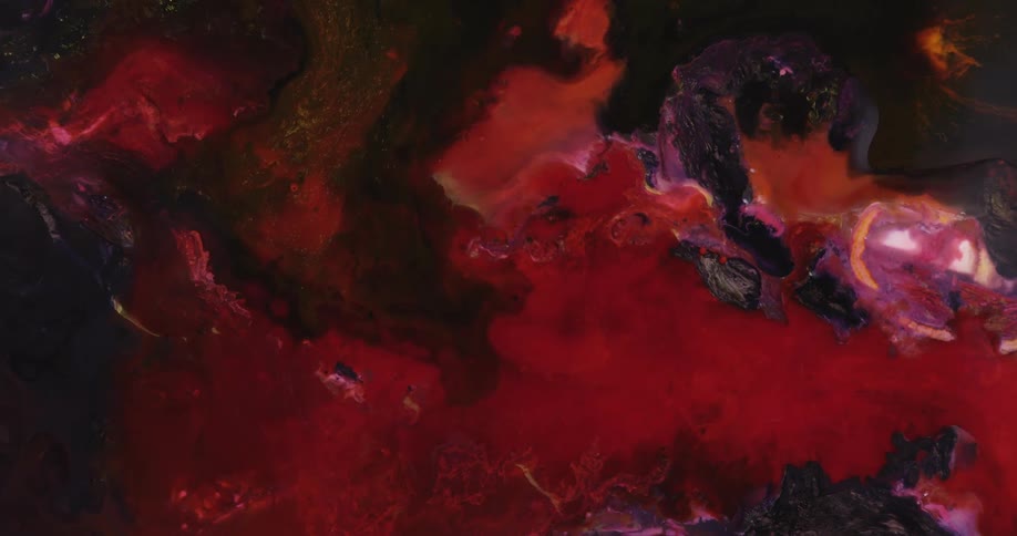 Dark hues of reds purples orange colors mix and swirl together in a beautiful outers pace like creation