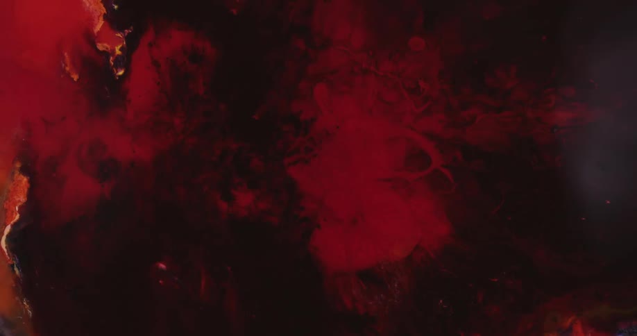 Red liquid moves through a black medium forming abstract patterns