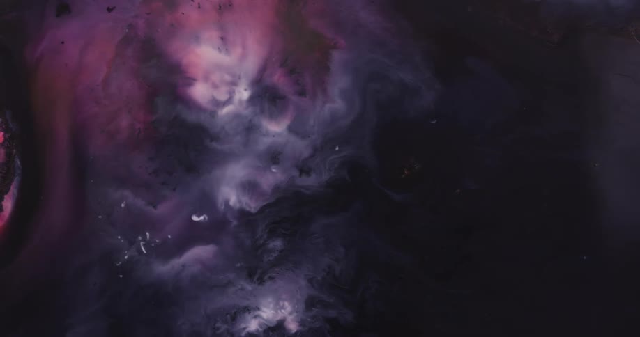 Pink black and white liquid blend together as it spreads
