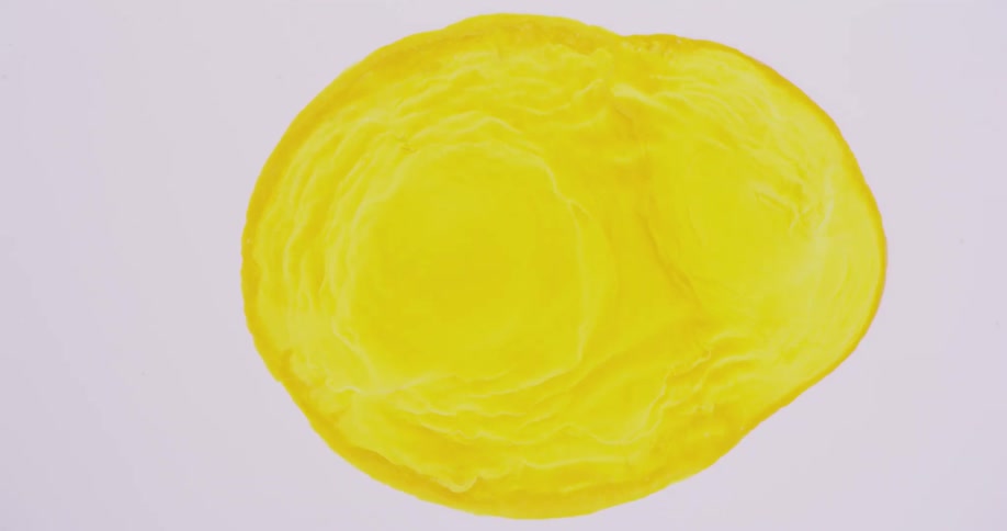 A yellow blob with darker edges is growing over a whitish pink area