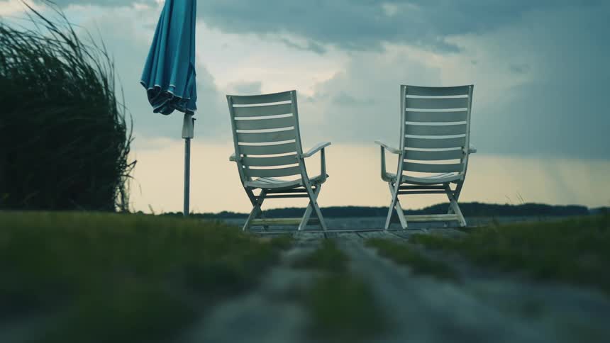 Two empty chairs in the wind before a hurricane