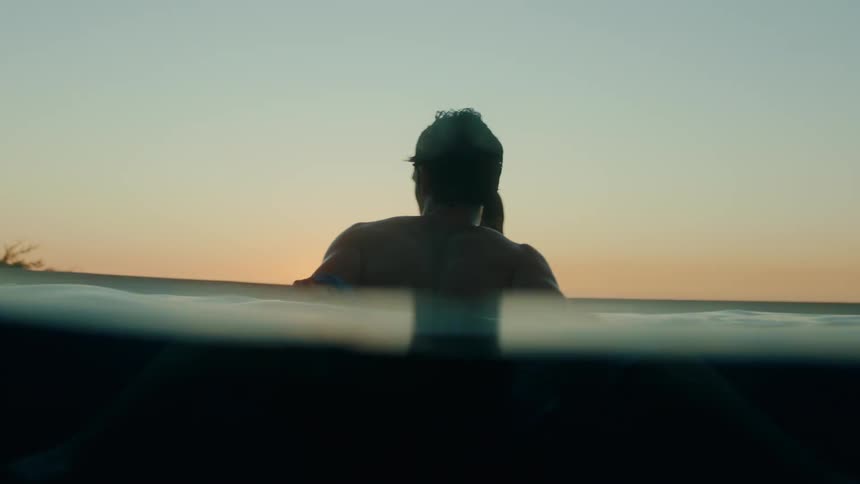 A man and woman are kissing in the lake together