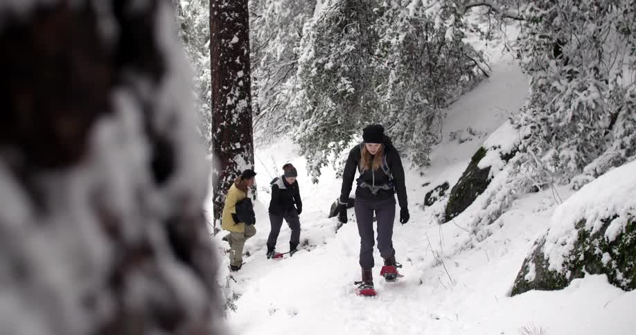 Some people hike up a snowy path