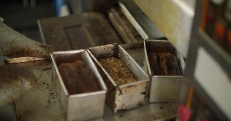 A person taking food out of an oven