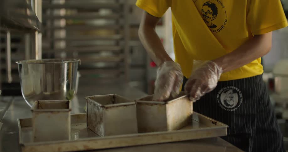 A man is preparing dough in the kitchen