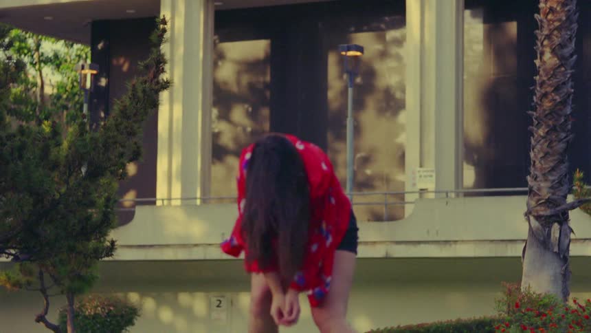 A woman is dancing outside