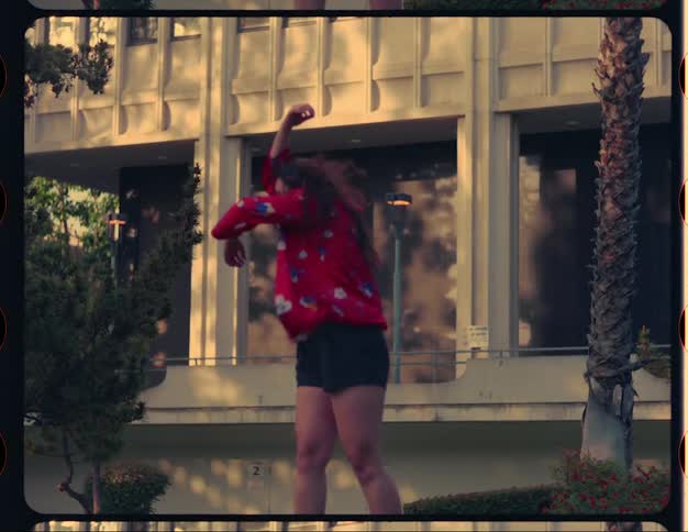A woman is dancing outside