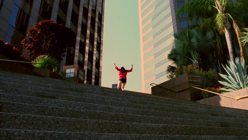 Female dancer dances between steps and building