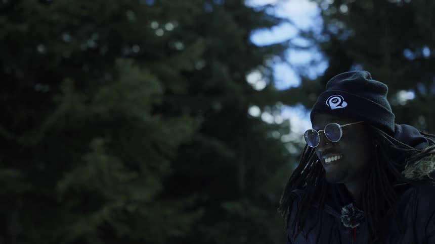 A man is walking outdoors and smiling
