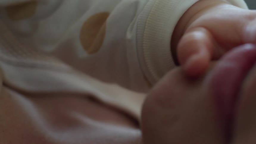 A baby touches a womans face