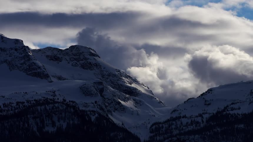 Thick clouds roll over mountain tops