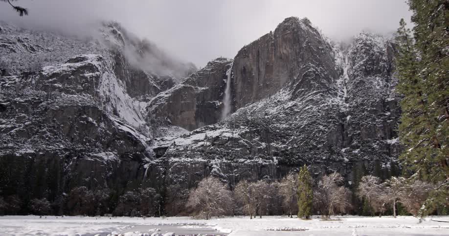 A waterfall in a wintry, mountain landscape