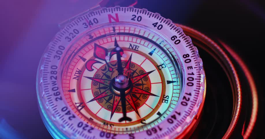 The needle on a compass spins back and forth rapidly