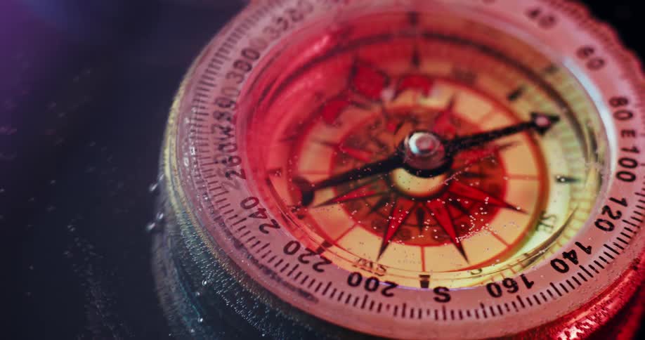 A compass is underwater and the arrow spins wildly