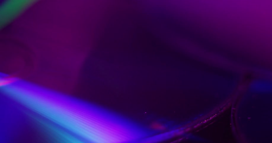 Light flashes across iridescent surface of optical discs