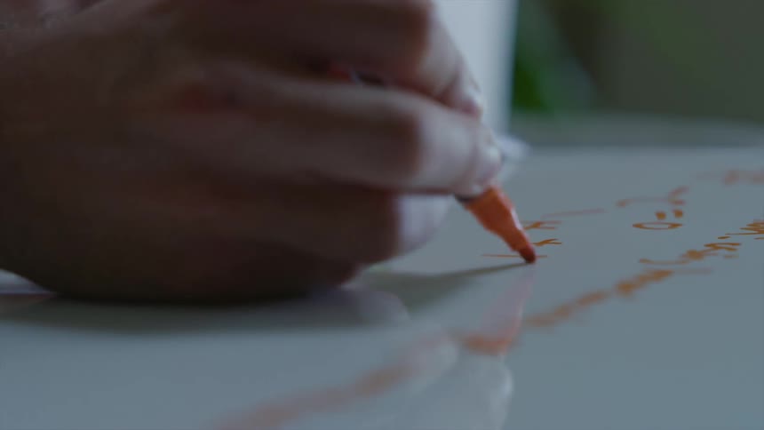 A woman writing on a dry erase board