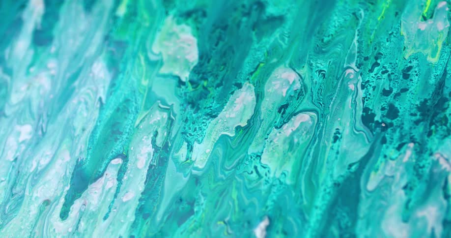 Blue and green painted swirls on an art canvas move and shift