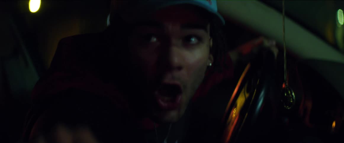 Man sitting in drivers seat yells and throws his hat