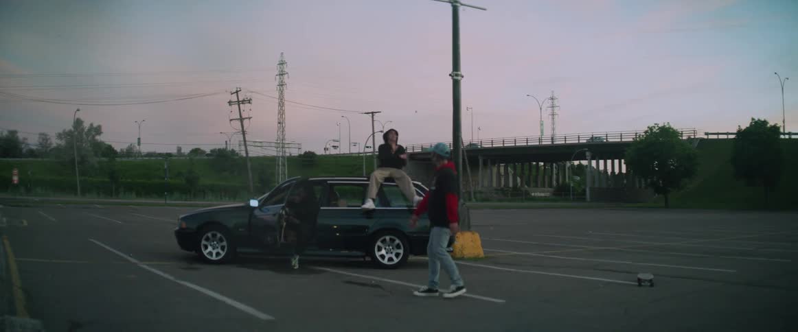 Teenagers are playing around by the car