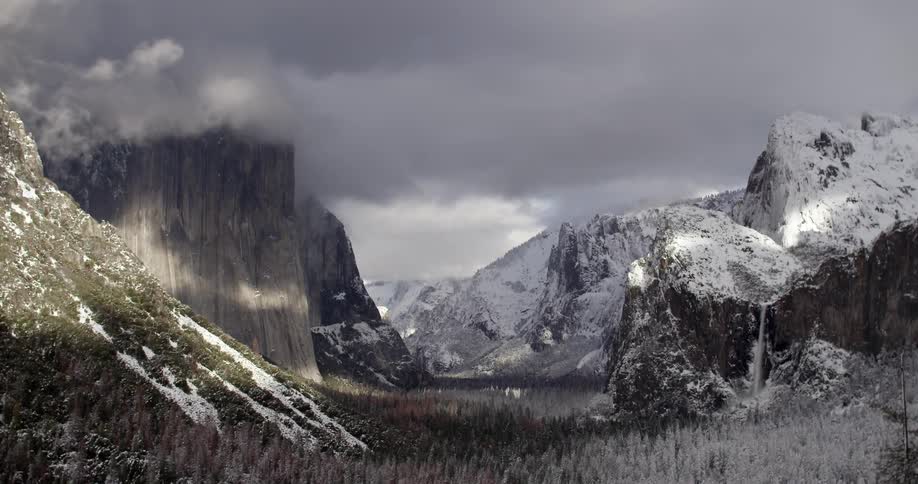 The clouds cover the top of this snow covered mountain