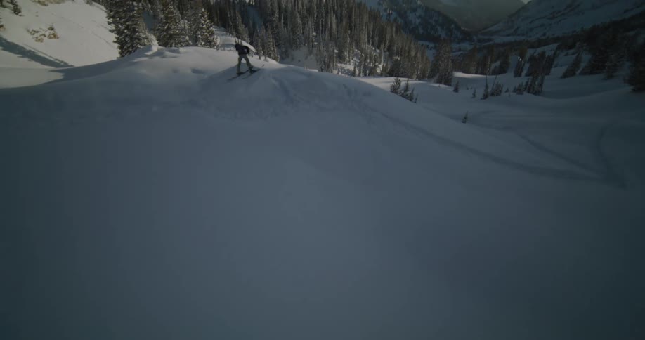 A skier hits a snow covered ramp and crashes after flipping and twirling