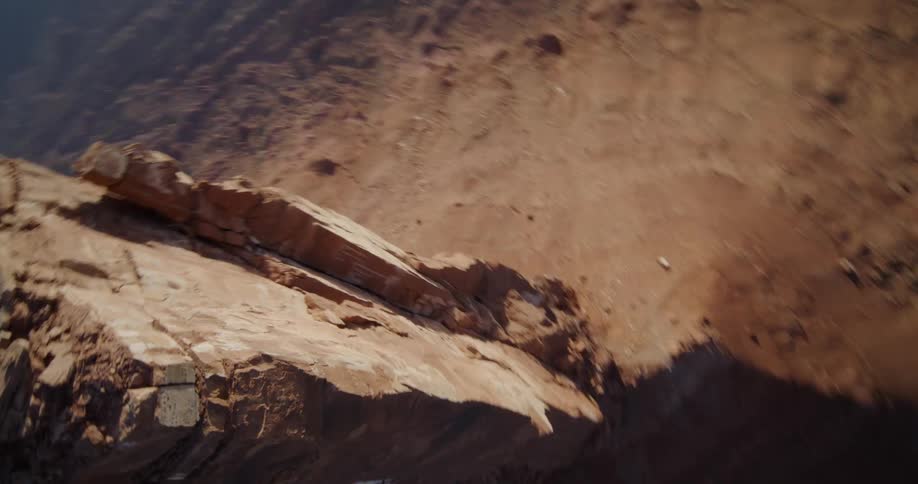 A tall mesa casts a shadow onto the ground below