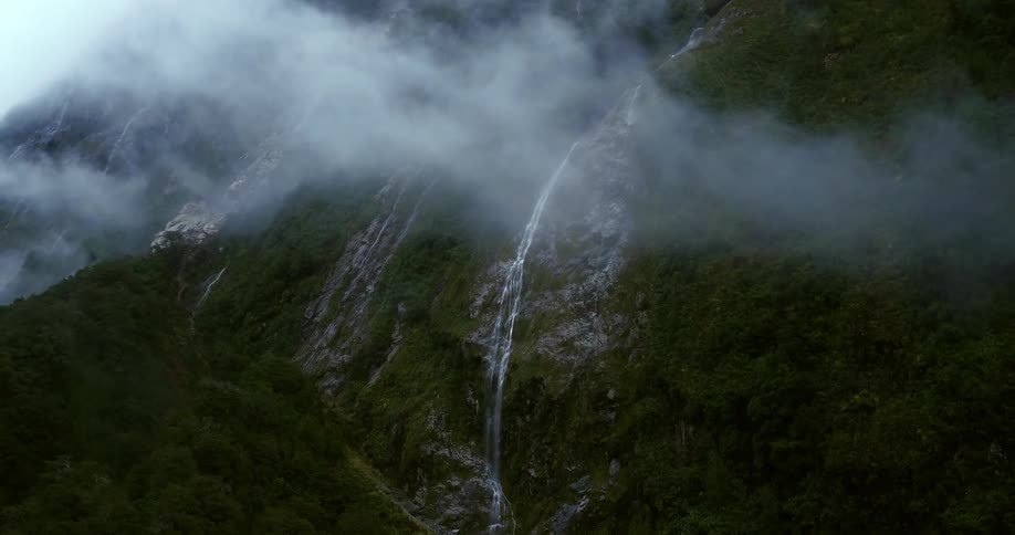 A waterfall on a tree covered mountain