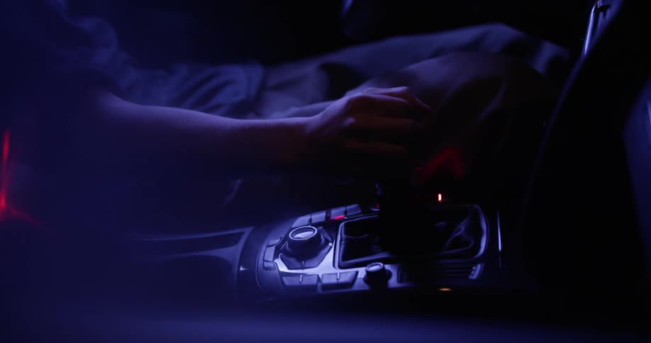 A person puts their car into gear