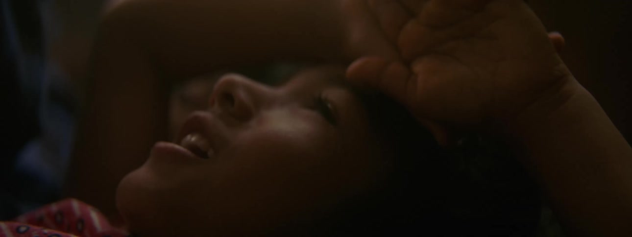 Two kids are laying down and talking