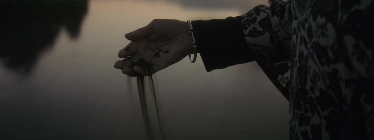 A person drops sand from their hand