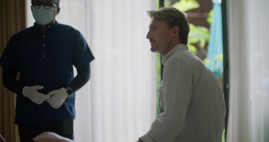 A doctor checking on a patient at their house