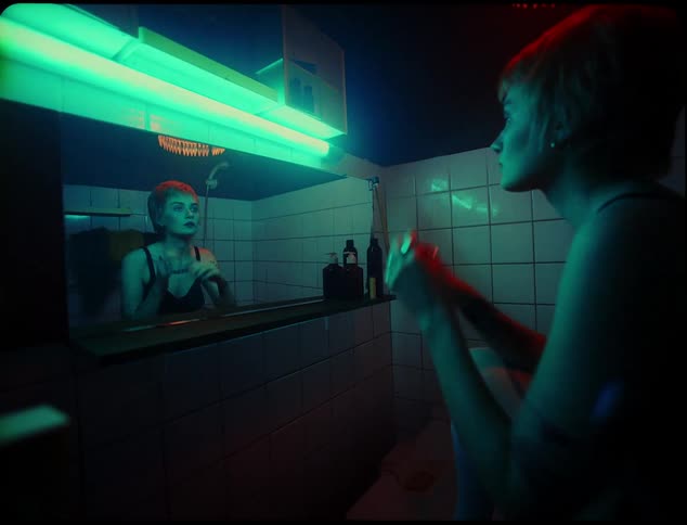 A woman brushes her hair in the mirror